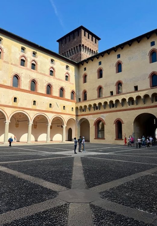 The porticoes of the Corte Ducale at Sforza Castle beneath a square brick tower