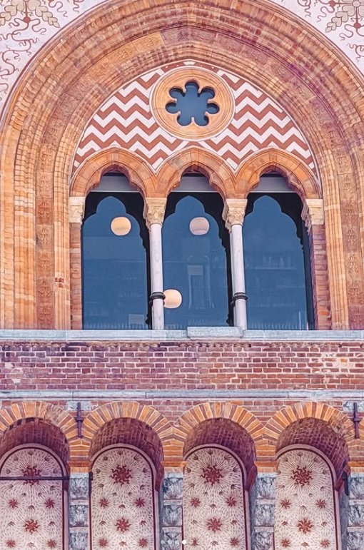Arched terracotta windows set into the brick