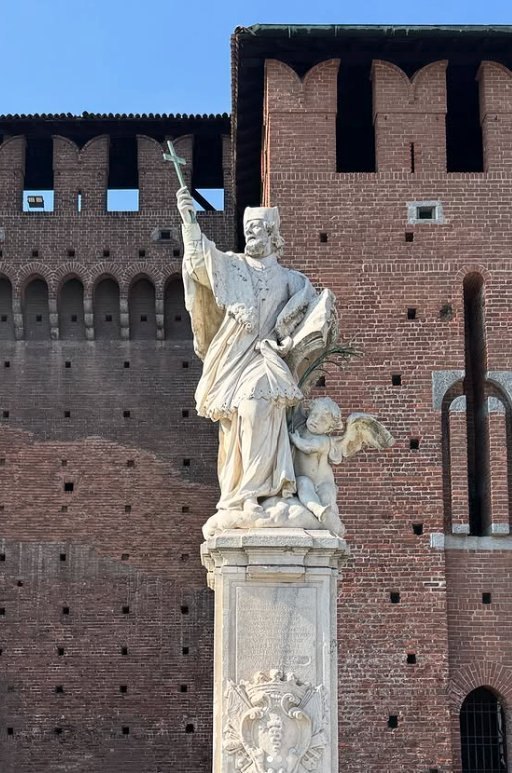A white marble statue against the battlemented wall
