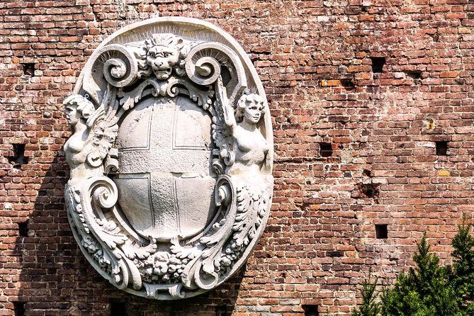 A carved stone coat of arms in the castle wall