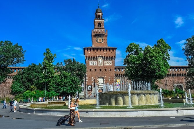 Piazza Castello in summer, the castle's brick front behind the square